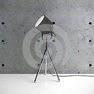 Metalic tripod lamp and concrete wall in empty room