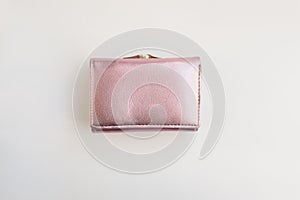 Metalized pink pastel female wallet on a white background flat layout view reconciliation. Business, finance, money