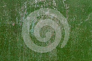 Metallic background with green cracked paint on the surface