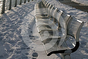 The metallic benches and the white snow during winter