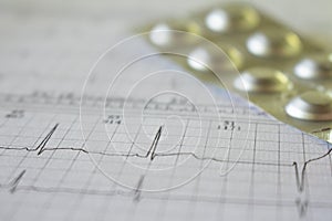 Metallic blister on an electrocardiogram paper. Medications for cardiac patients