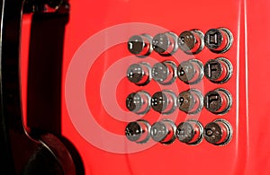Metallic buttons of a payphone with braille table, abstract photo