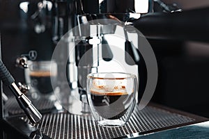 Metallic clean silver coffee machine in process of making fresh coffee. Preparing coffee at home. Home barista.