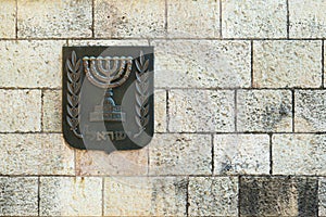 Metallic coat of arms of Israel on the stone wall
