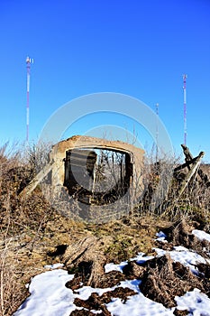 Metallic communication pillars and historical barn ruins