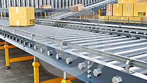 Metallic conveyors with boxes are stretching far away, stack of boxes is near, photo