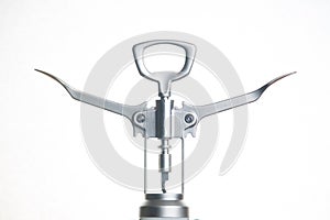 Metallic corkscrew with two levers like humanoid robot spreads it`s arms wide on a white background