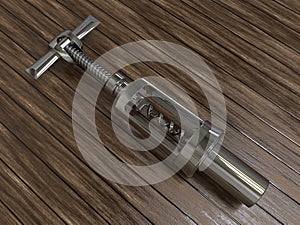 Metallic corkscrew on a wooden background