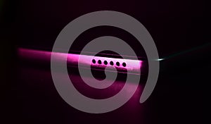 Metallic device with pink light effects