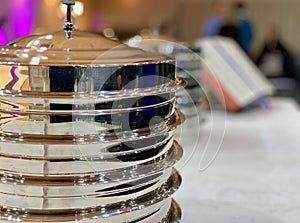 Metallic dishes prepared for the Lordâ€™s Supper in a Baptist Church