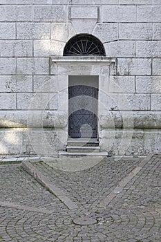 The metallic door of The Bell Tower of Parish Church Santi Filippo e Giacomo Apostoli in Cortina d`Ampezzo.