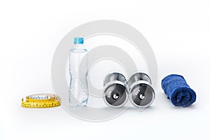 Metallic dumbbells, bottle, measuring tape and towel isolated on white