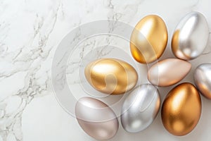 Metallic easter eggs in gold, silver, and bronze on marble surface for elegant holiday decor