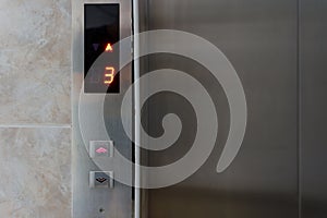 Metallic elevator panel with button and led display.  Interior and closeup of metal buttons in elevator