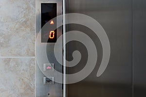 Metallic elevator panel with button and led display.  Interior and closeup of metal buttons in elevator