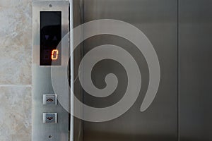 Metallic elevator panel with button and led display.  Interior and closeup of metal buttons in elevator
