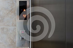 Metallic elevator panel with button and led display.  Interior and closeup of metal buttons in elevator