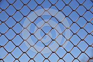 Metallic fence net against the sky, background, texture