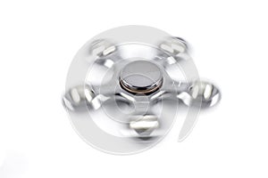 A metallic fidget spinner in spin mode