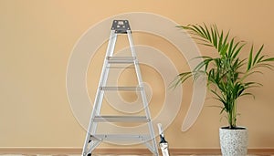 Metallic folding ladder and painting tools near beige wall indoors photo