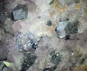 Metallic galena crystals among smaller light purple fluorite crystals
