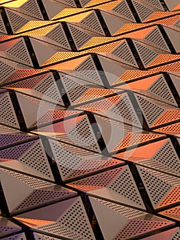 Metallic geometric cladding or panels in copper and gold colours