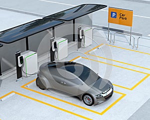 Metallic gray autonomous car recharging in parking lot photo