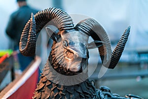 The metallic head of ram. The statue head aries
