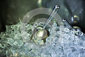 Metallic ladle with ice cubes