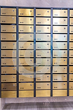 Metallic mailbox array in lobby of condominium building