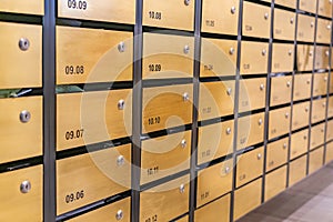 Metallic mailbox array at postal room inside modern apartment building