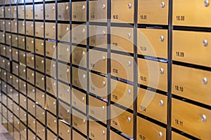 Metallic mailbox rows at postal room inside condominium building