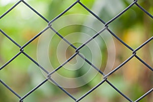 Metallic mesh fence closeup background texture