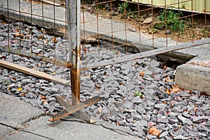 Metallic mesh fence on the road under construction