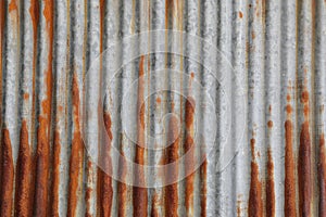 Metallic metal steel tin fence wall sheet  damaged by red brown rust zinc. Concept of wallpaper texture and background