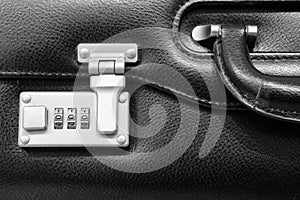 Metallic numerical lock of a black leather briefcase