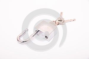 Metallic padlock with three keys in keyhole