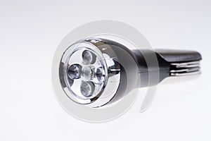 Metallic portable LED flashlight isolated on white