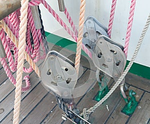 Metallic pulley block and ropes on the deck