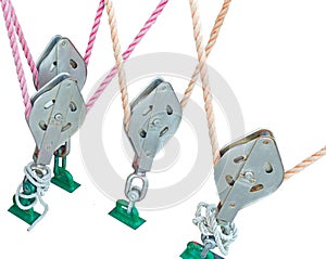 Metallic pulley block and ropes on white