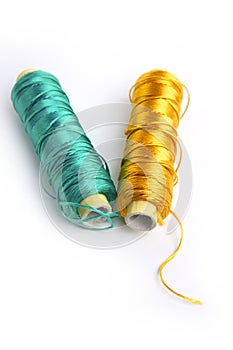 Metallic rayon thread line spool green and gold photo