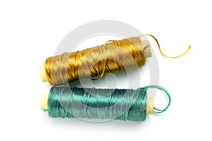 Metallic rayon thread line spool green and gold photo