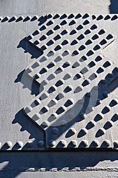 Metallic rivets on the iron background - industrial pattern - ironworks