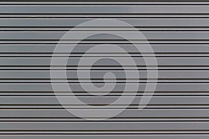 Metallic roll up door. Old Steel rolling shutter background.