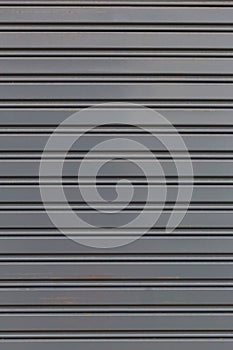 Metallic roll up door. Old Steel rolling shutter background.