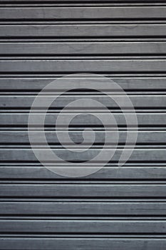 Metallic roll up door. Old Steel rolling shutter background.