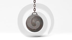Metallic rusty wrecking ball on chain
