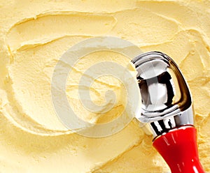 Metallic scoop on creamy banana yellow ice cream