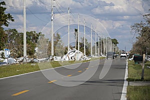 Metallic scrap rubbish on roadside from hurricane severely damaged houses in Florida residential area. Aftermath of