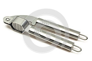 Metallic shiny garlic press crusher tool isolated on white background. Stainless kitchen utensil mincer